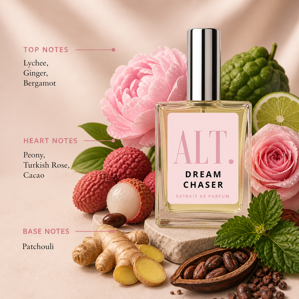 Perfume bottle labeled 'ALT. Dream Chaser' surrounded by flowers, fruits, and spices on a soft pink background.