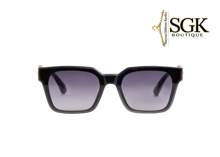 Black sunglasses with gradient lenses on a white background, featuring the SGK Boutique logo.