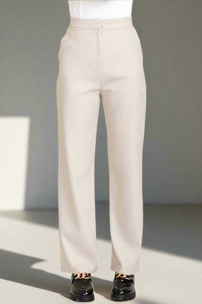 Beige pants worn by a person on a white background