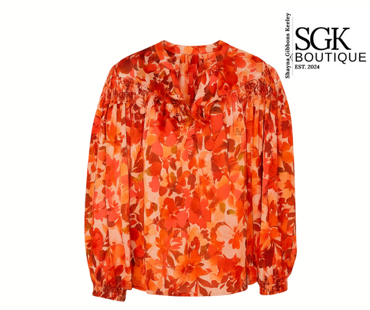 Orange floral blouse on a white background with SGK Boutique logo.