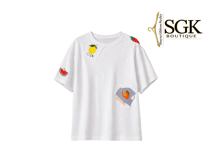White t-shirt with colorful fruit patches on a white background, featuring the SGK Boutique logo.