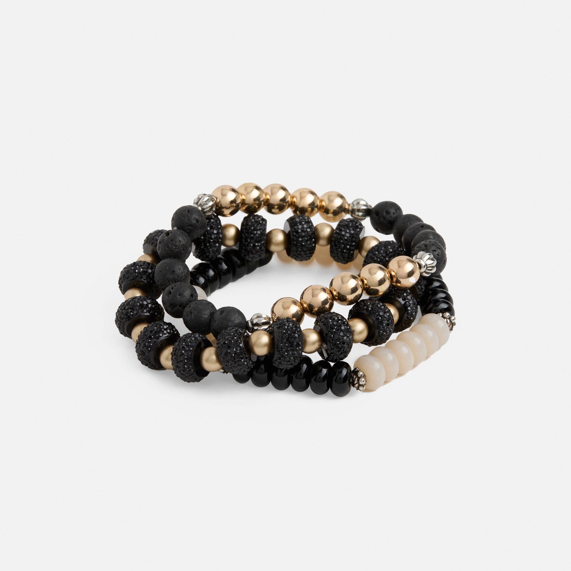 Set of black, gold, and white beaded bracelets on a light gray background
