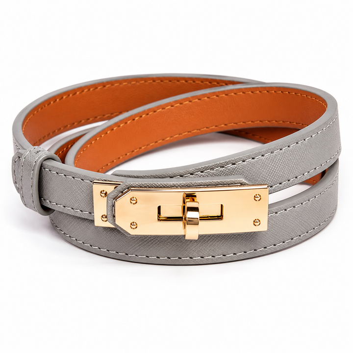 Gray leather bracelet with gold clasp on a white background