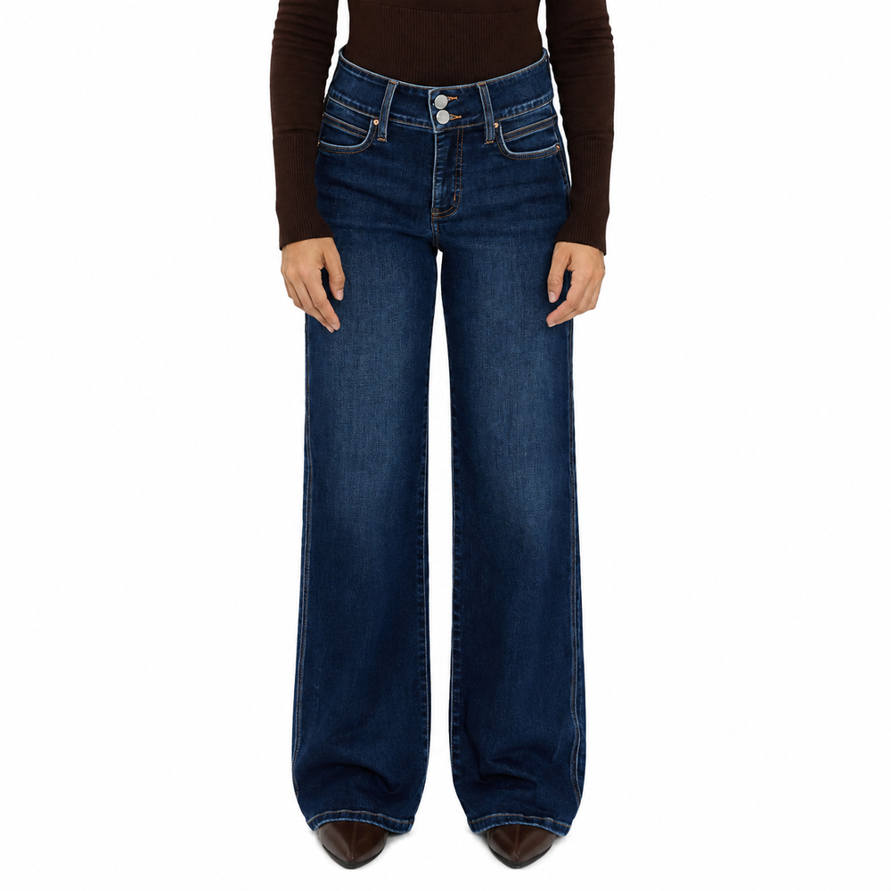 A person wearing dark blue wide-leg denim jeans with a brown long-sleeve top, shown from the waist down against a plain white background.