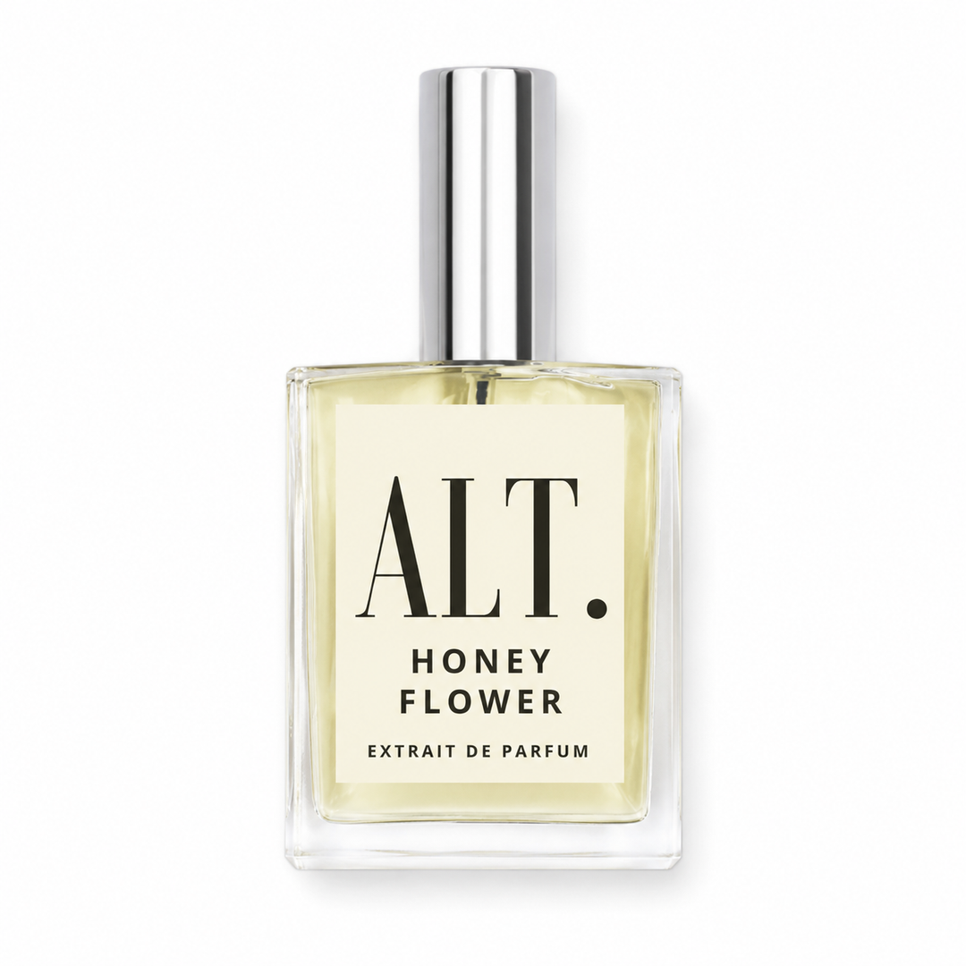 A rectangular glass bottle of ALT. Honey Flower Extrait de Parfum with a silver cap, containing a pale yellow liquid, set against a plain white background.