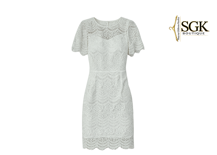 White lace dress on a white background with SGK Boutique logo.