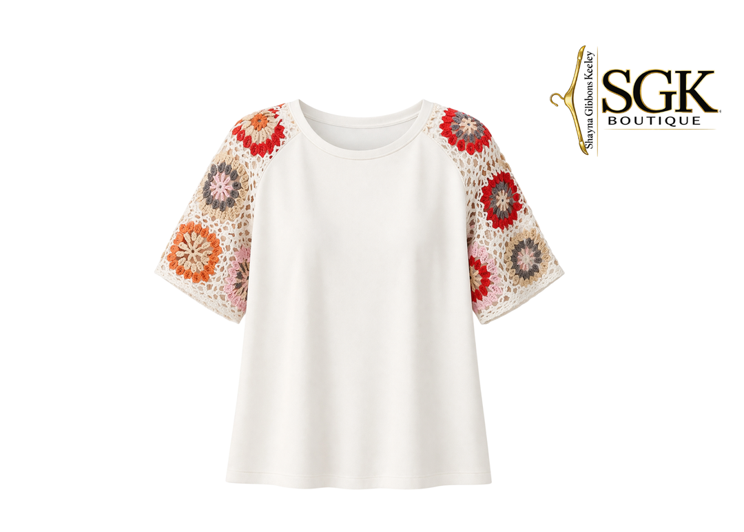 White top with floral sleeves on a white background, featuring the SGK Boutique logo.