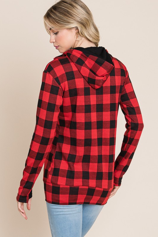 Red and black checkered hoodie worn by a person on a beige background