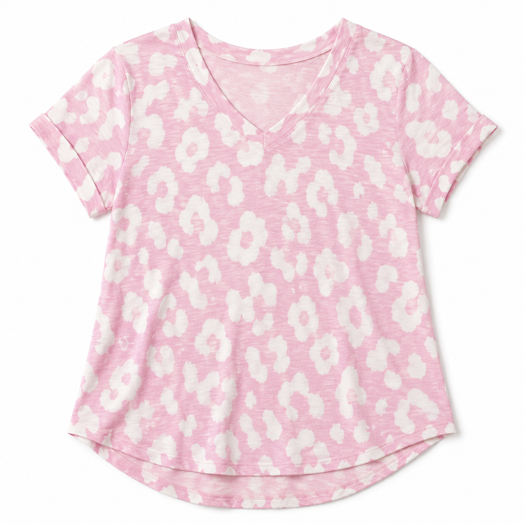 A pink short-sleeve V-neck t-shirt with a white abstract floral or leopard-like spot pattern, shown flat against a white background.