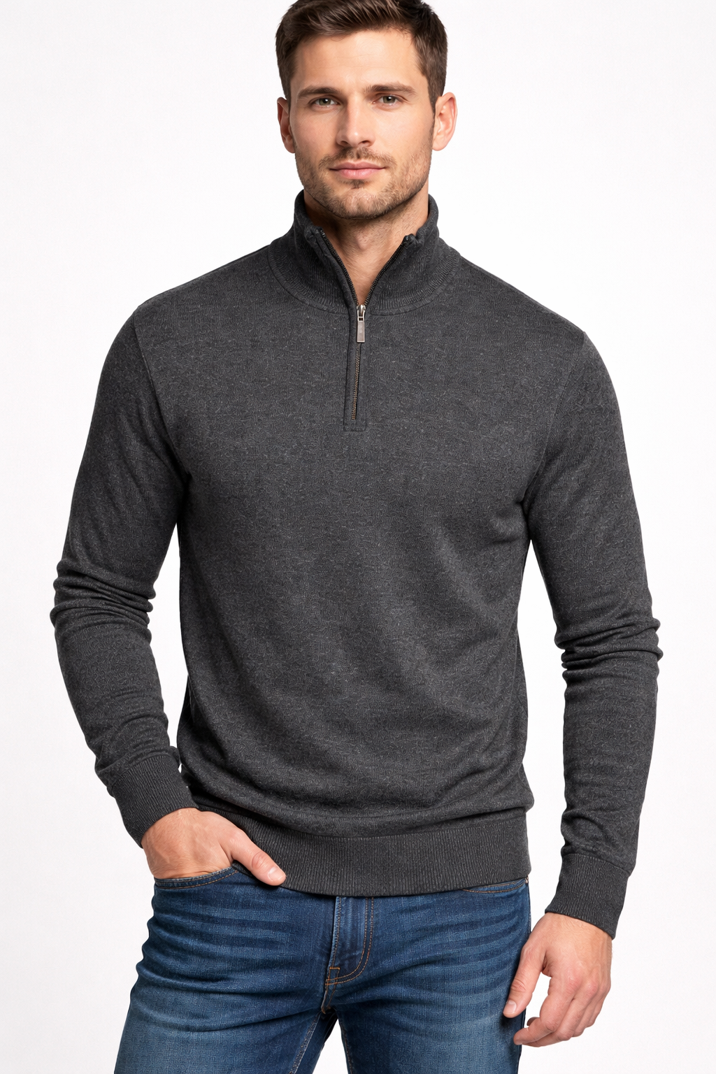 Man wearing a dark gray quarter-zip sweater and blue jeans on a white background