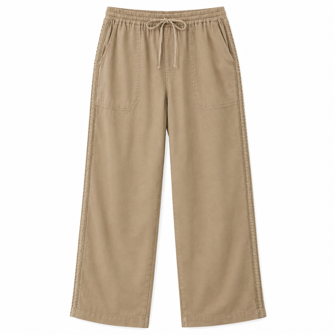 A pair of wide-leg cropped pants in a warm tan or khaki color, featuring an elastic waistband with a drawstring, side pockets, and decorative contrast stitching running down the outer seams.