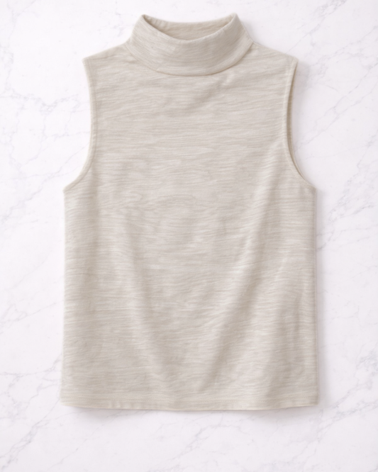 Beige sleeveless turtleneck top on a textured white background