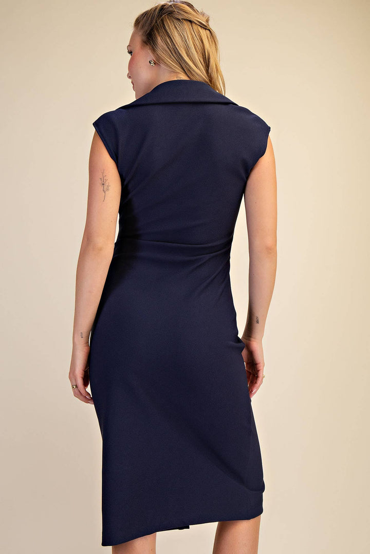 Navy blue dress worn by a person on a beige background
