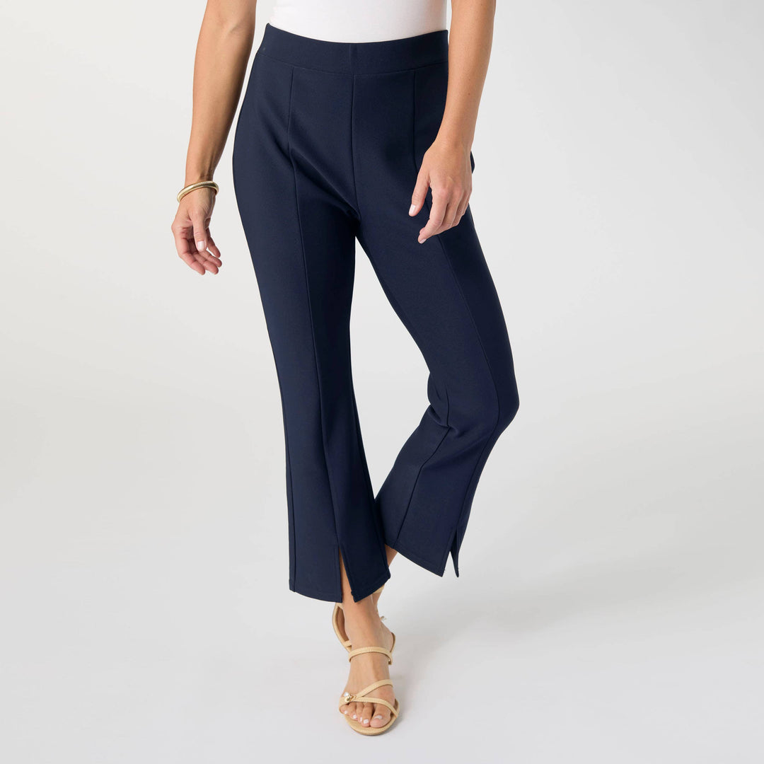 Navy blue capri pants worn by a person on a white background