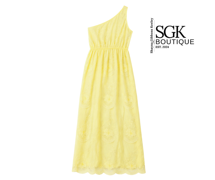 Yellow one-shoulder dress on a white background with SGK Boutique branding.