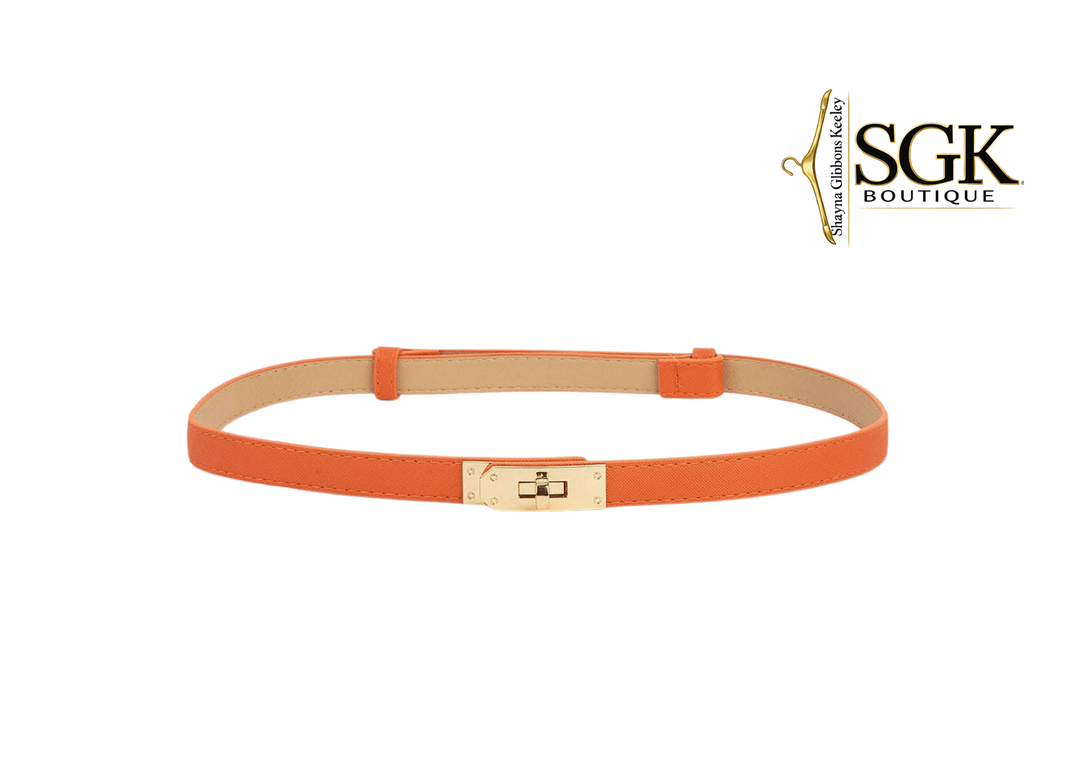 Orange belt with a gold buckle on a white background, featuring the SGK Boutique logo.