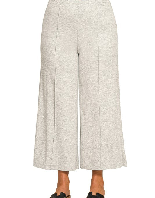 Light gray wide-leg pants worn by a person on a white background