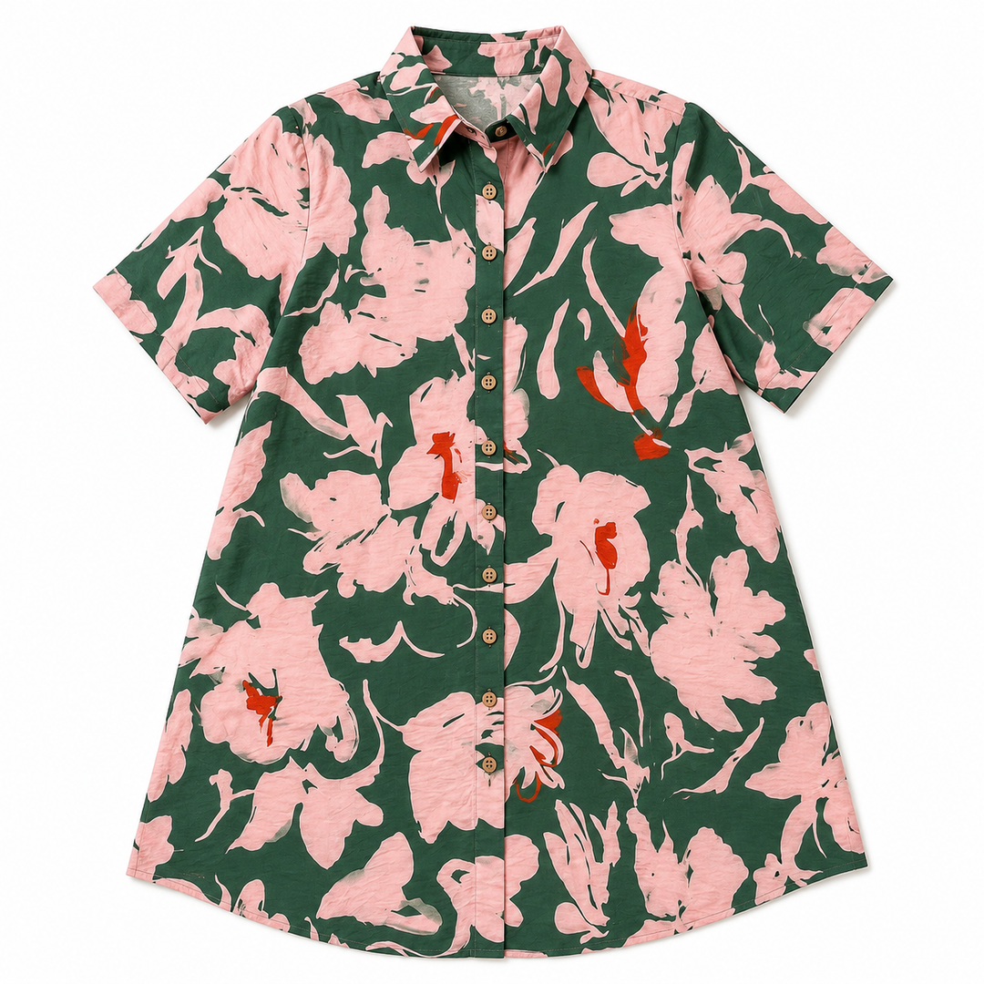A short-sleeve button-up shirt dress with a bold floral print in dark green, light pink, and small orange accents, displayed flat against a white background.