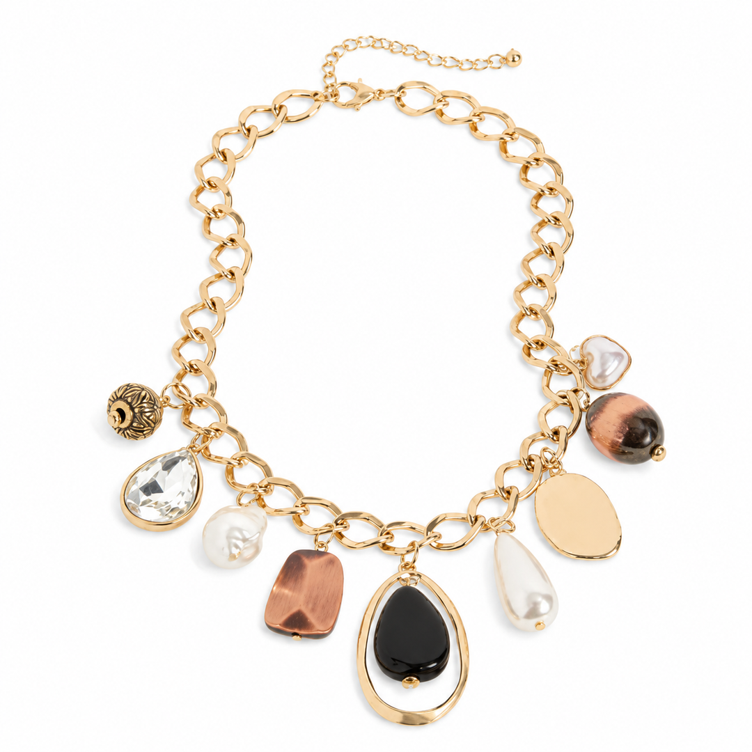 Gold necklace with various charms on a white background