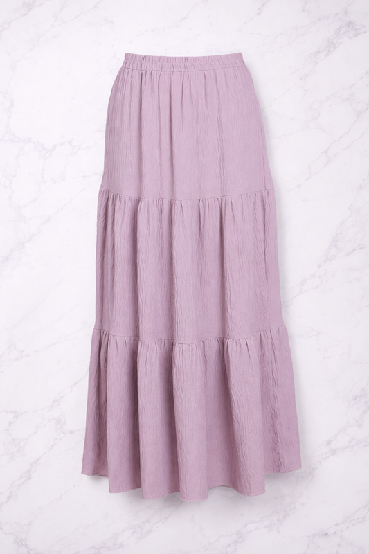 Purple tiered skirt on a white textured background