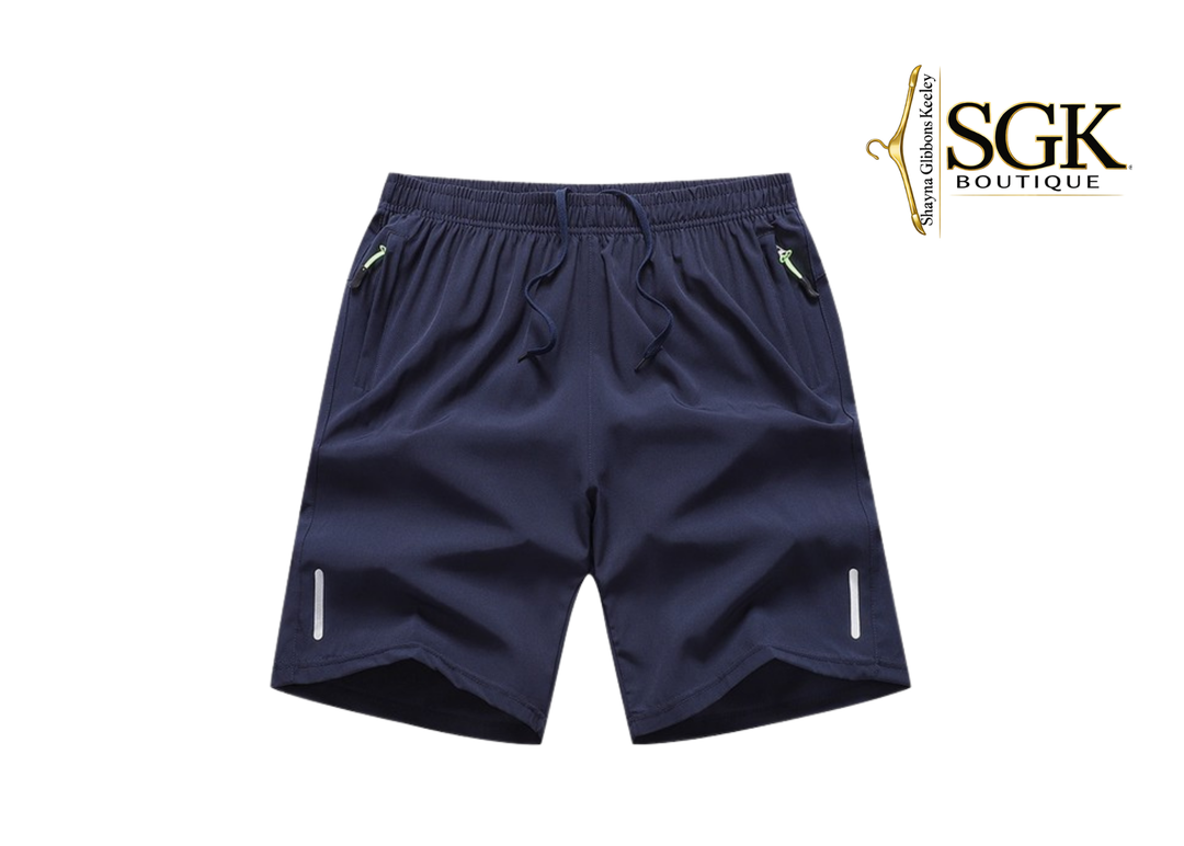 Navy blue shorts with white zippers on a white background, featuring the SGK Boutique logo.