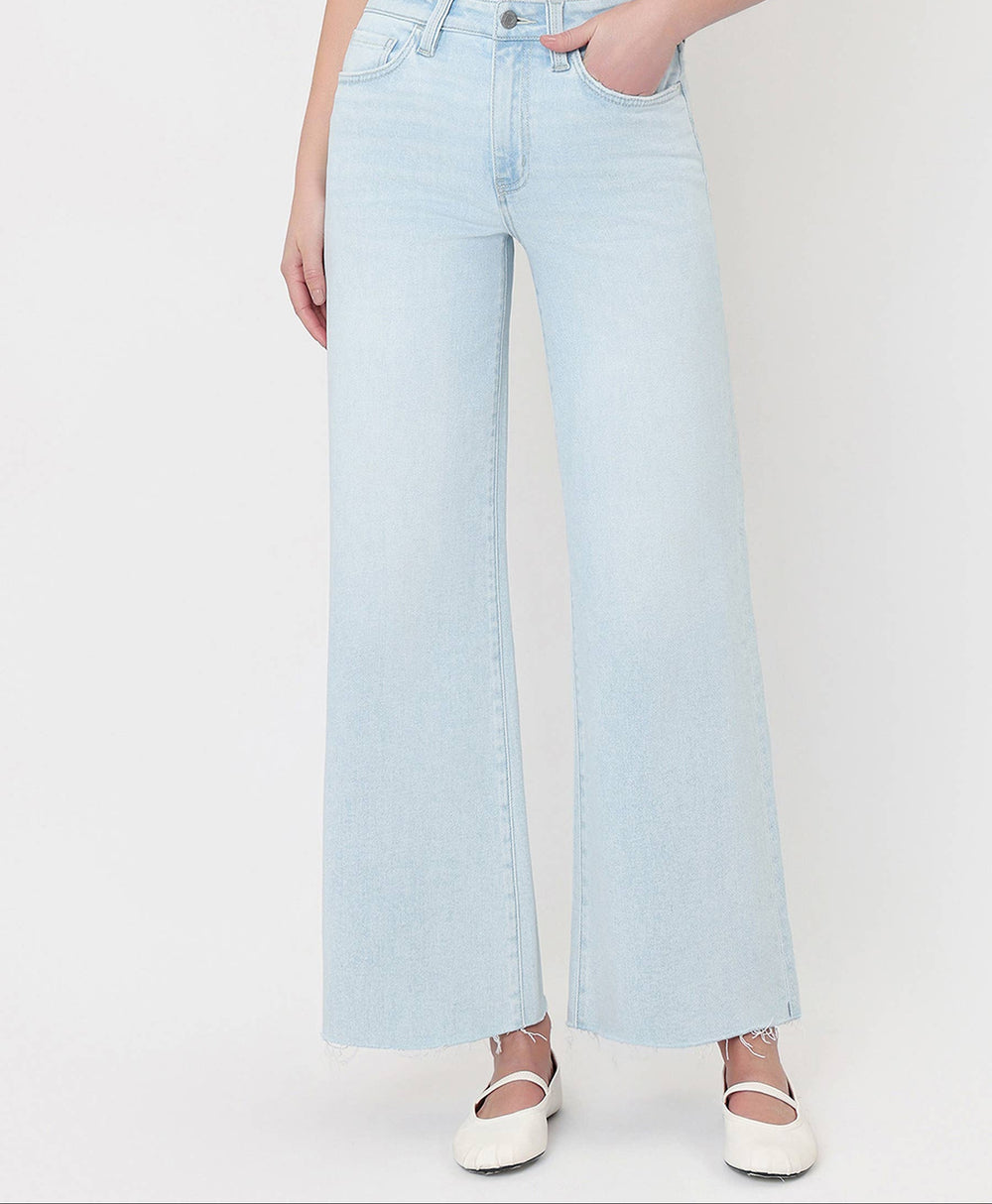 Light blue jeans worn by a person on a white background