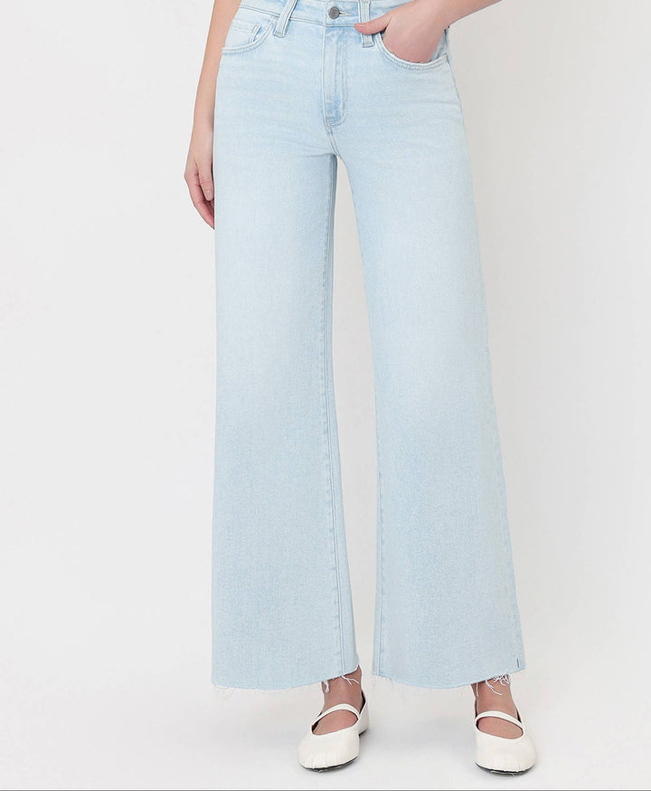 Light blue jeans worn by a person on a white background