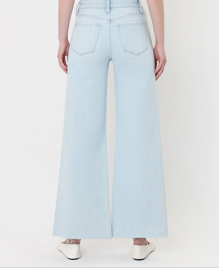 Light blue jeans worn by a person on a white background