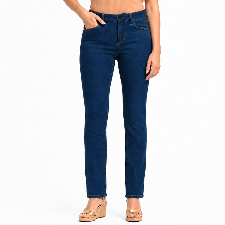 A model wearing dark blue slim-fit jeans with a straight leg, paired with a beige ribbed top and gold wedge sandals, shown from the waist down on a white background.