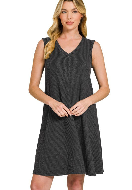 Woman wearing a black sleeveless dress on a white background