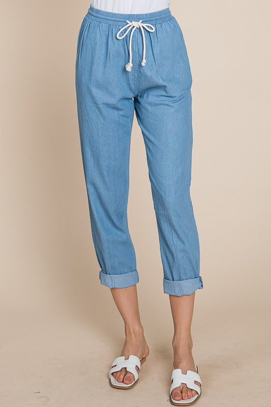Blue pants with a drawstring on a beige background