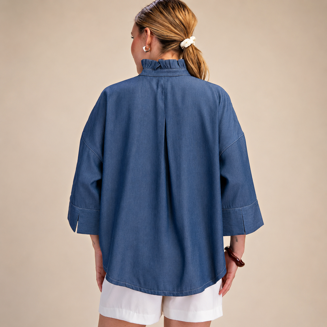 Person wearing a blue shirt and white shorts on a beige background