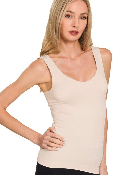 Woman wearing a sand beige tank top on a white background