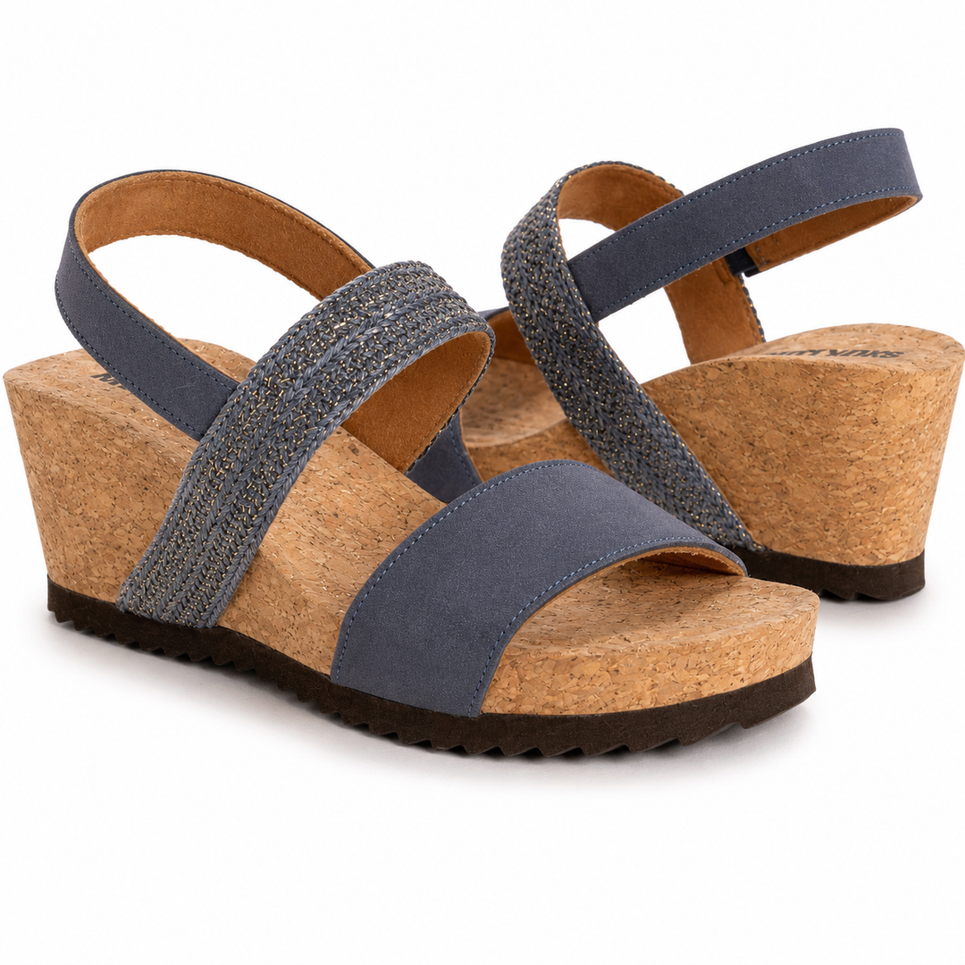 Pair of wedge sandals with blue straps and cork soles on a white background