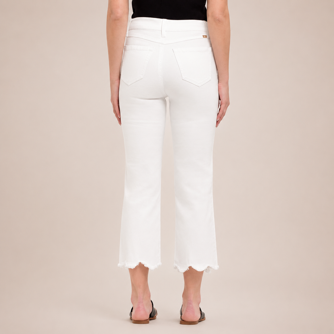 White pants worn by a person on a beige background