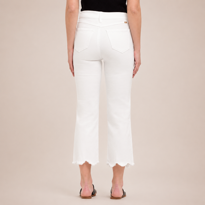White pants worn by a person on a beige background