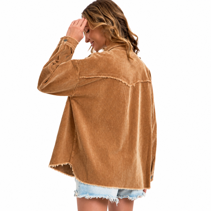 A woman shown from the back wearing a tan corduroy button-up shirt with raw, frayed edges and light blue denim shorts, set against a plain white background.