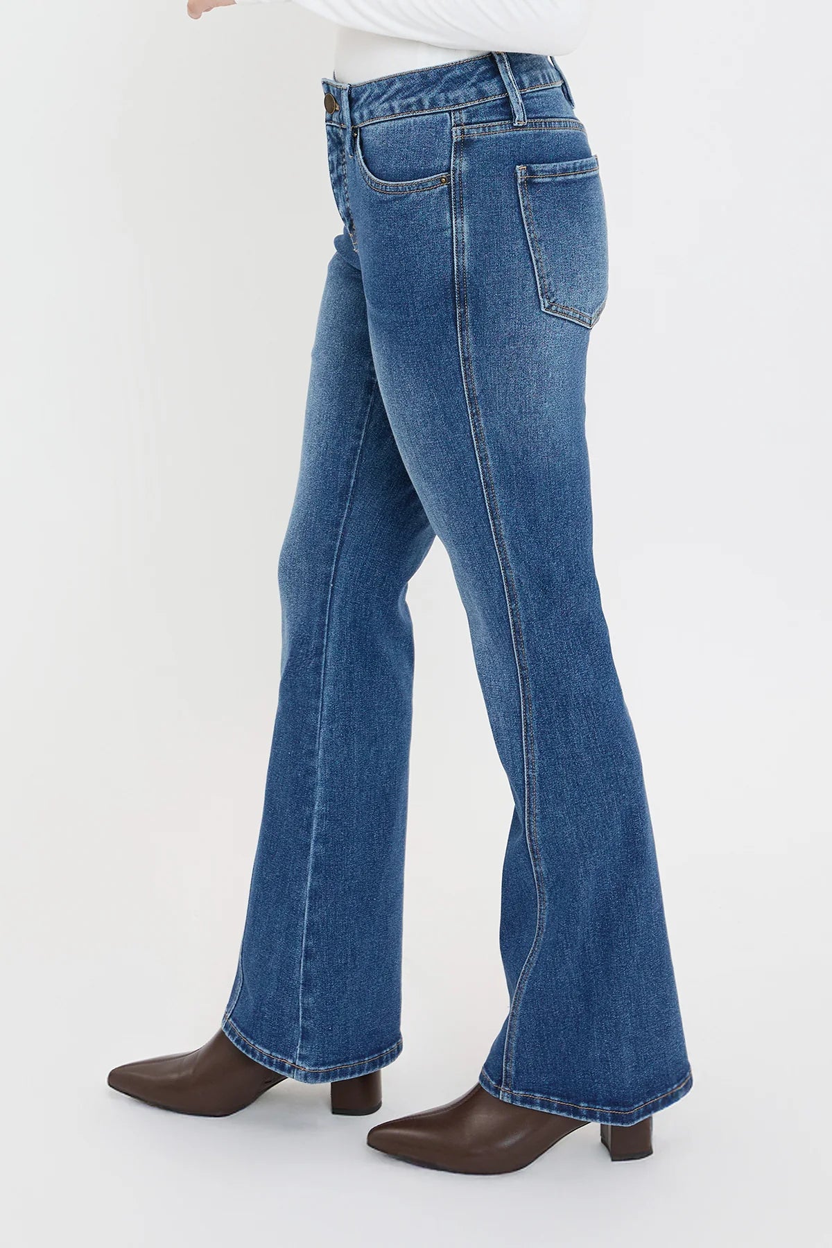 Blue jeans worn by a person on a white background