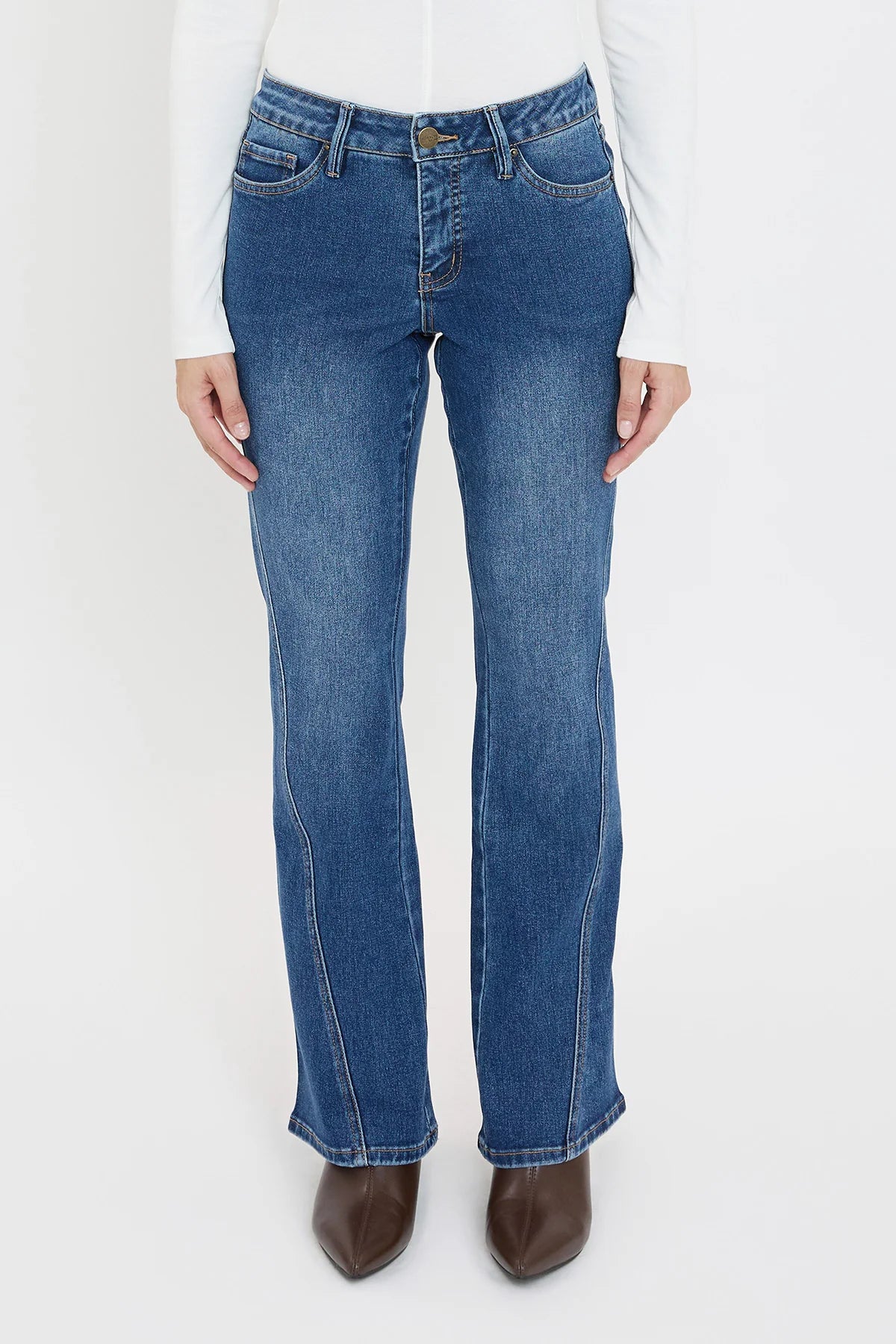 Blue jeans worn by a person on a white background