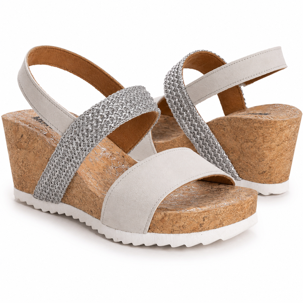 Wedge sandals with cork sole and silver straps on a white background