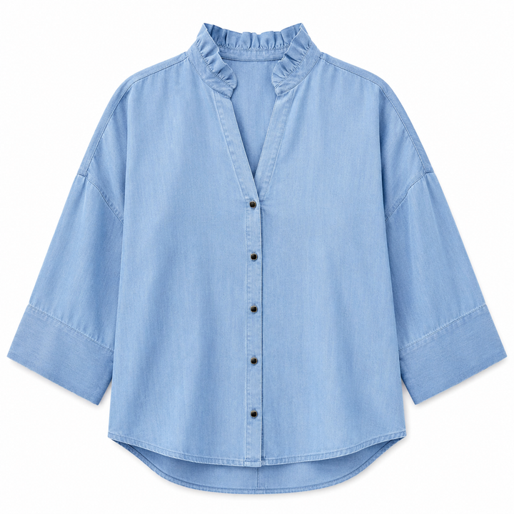 Light blue denim shirt with a ruffled collar on a white background