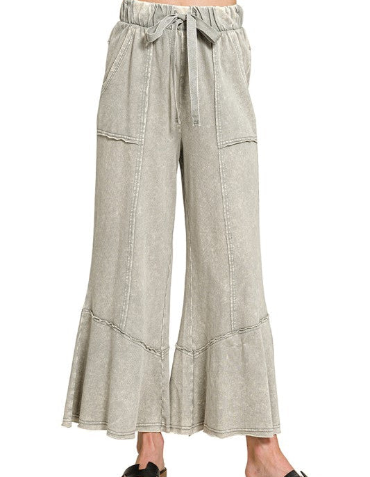 Light gray wide-leg pants with a tie waist on a white background