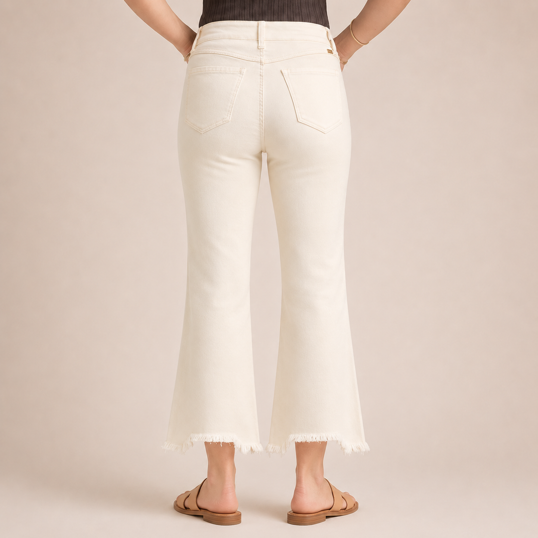 Person wearing white pants on a plain background