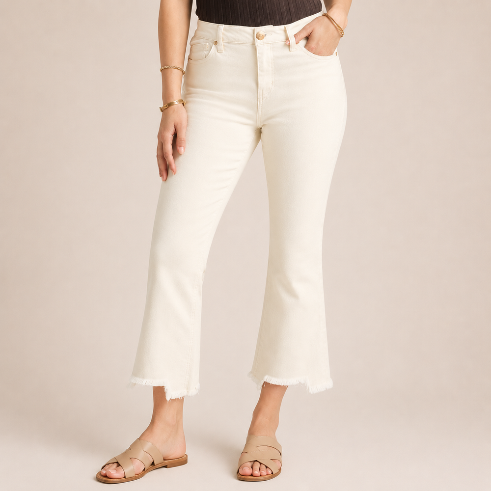 Person wearing white jeans on a plain background