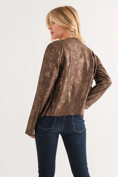 Woman wearing a brown leather jacket and blue jeans on a white background