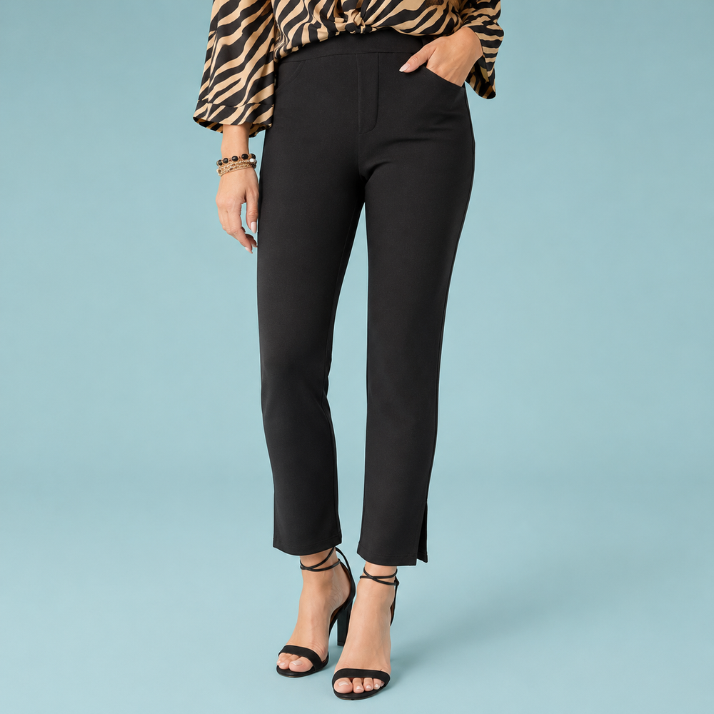 Person wearing black pants and a patterned top on a light blue background