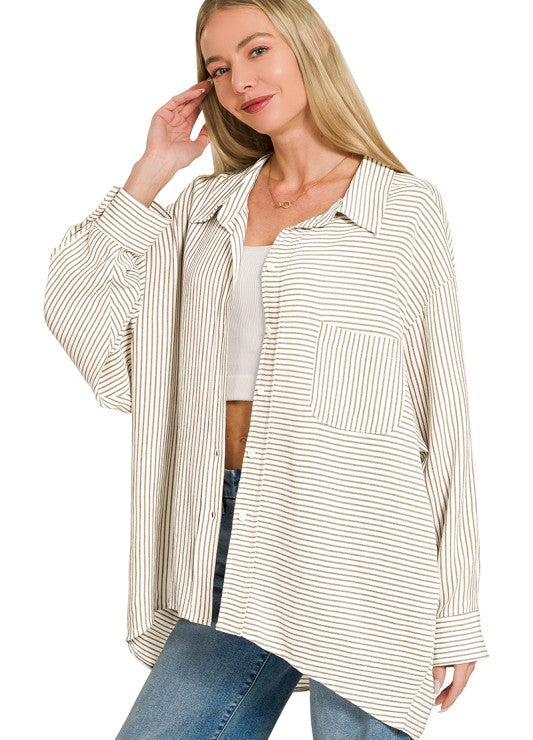 Woman wearing a beige and white striped shirt with a plain background