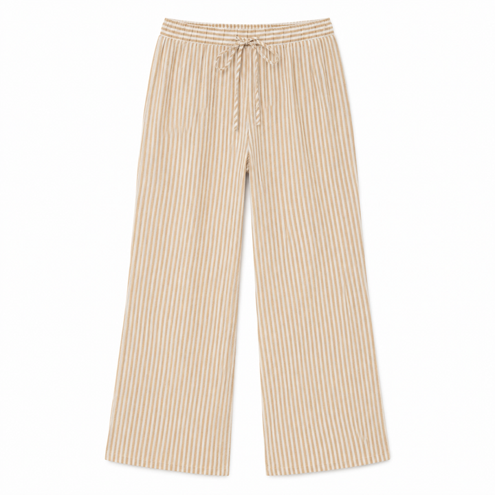 A pair of wide-leg pants featuring a vertical beige and white stripe pattern, a matching drawstring waist, and a relaxed straight-leg silhouette, shown flat against a plain white background.