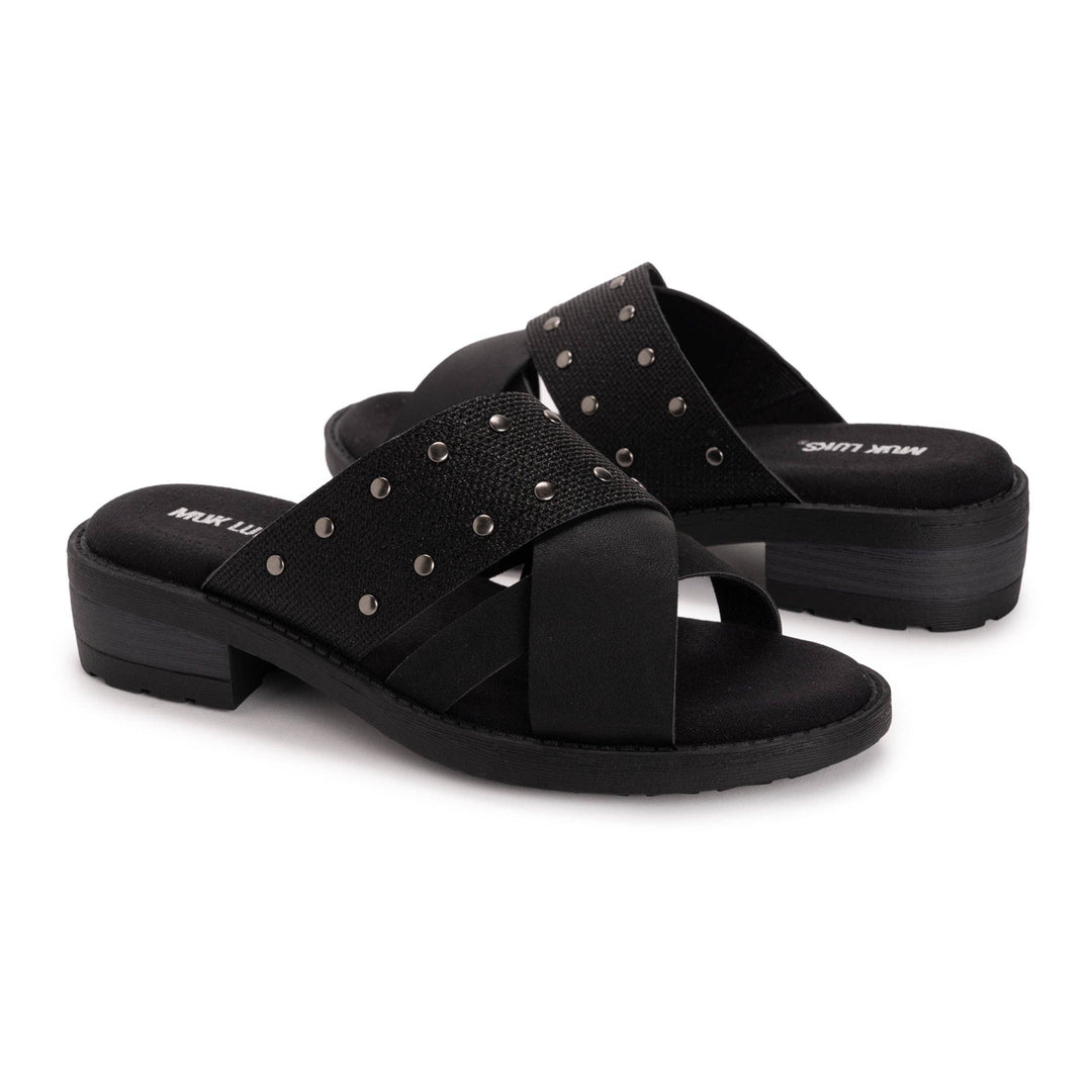 Black sandals with criss-cross straps and stud details on a white background