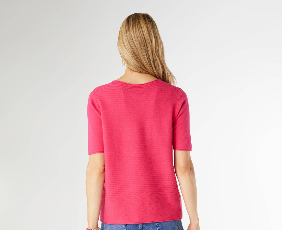 Person wearing a pink top and blue jeans on a white background